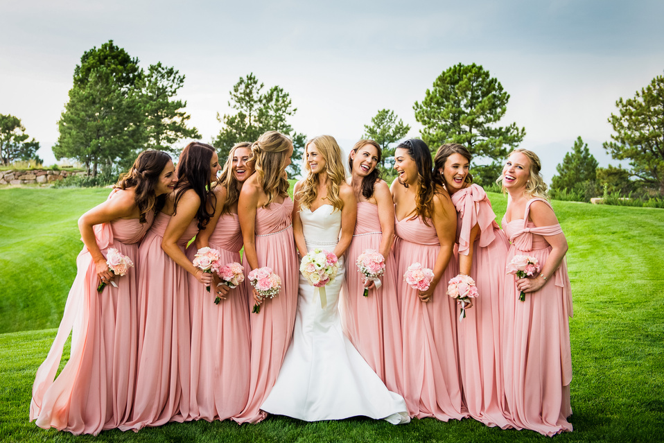 A group of a bride and her bridesmaids pose for a photo on the golf course at The Sanctuary in Sedalia, Colorado.