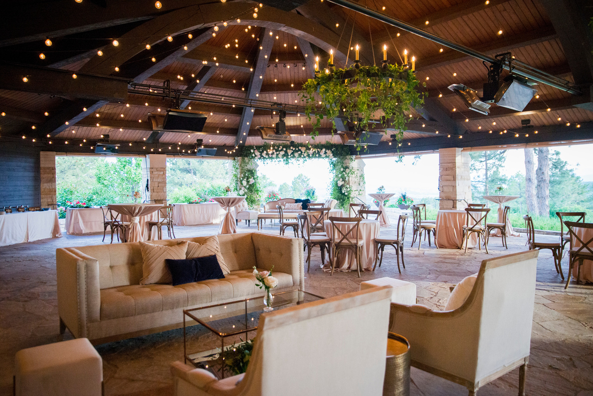 An outdoor wedding reception at The Sanctuary with chairs, tables and chandeliers.