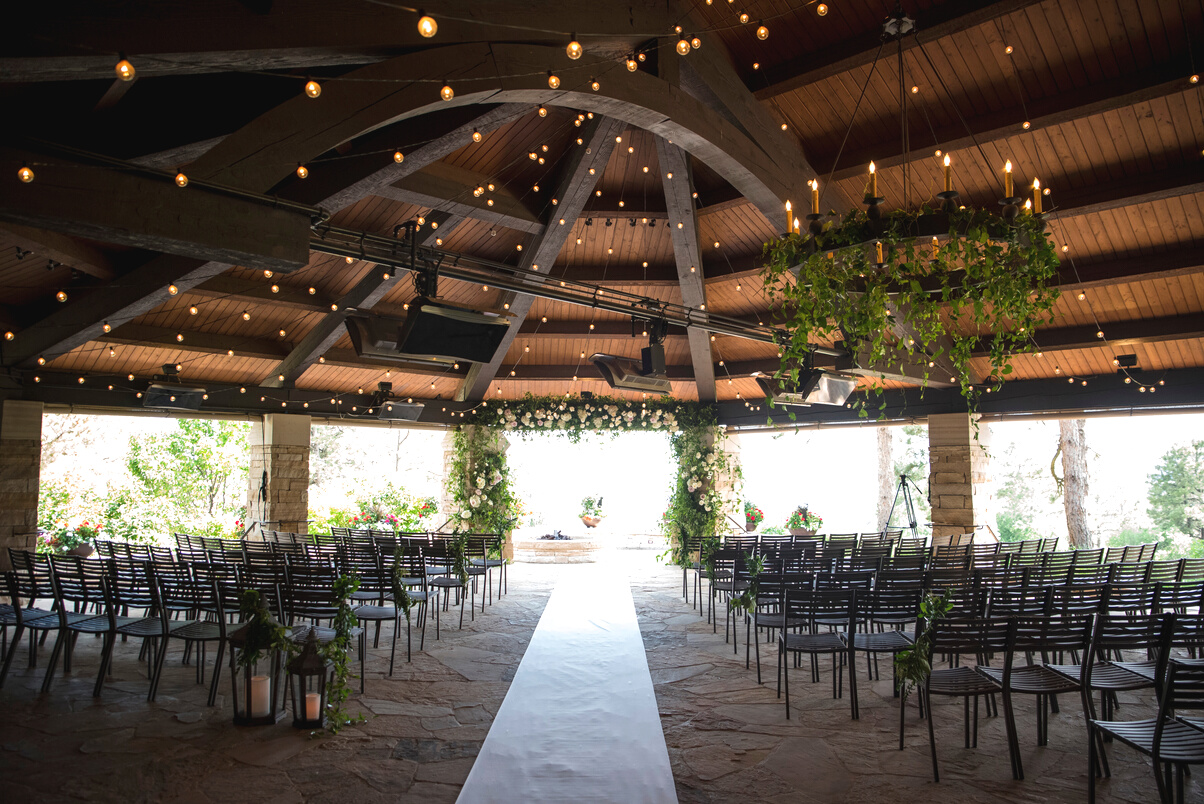 A wedding ceremony in a gazebo with string lights at The Sanctuary in Sedalia, Colorado.