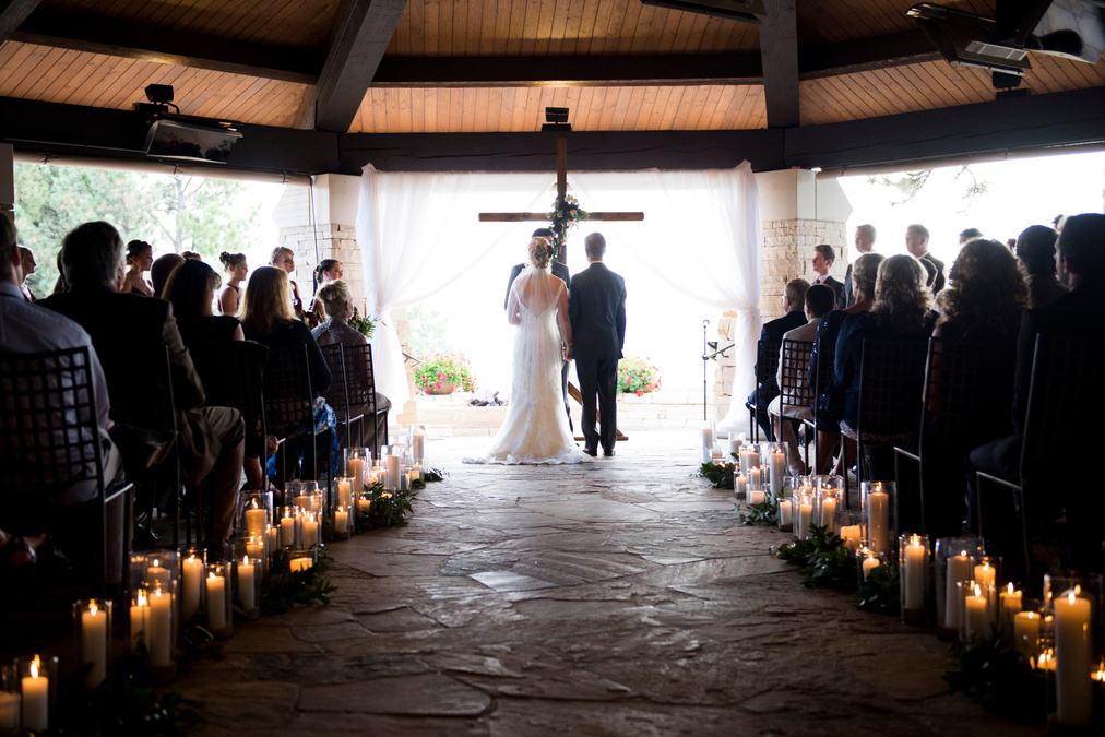 A bride and her father walk down the aisle during the wedding ceremony at Denver wedding venue, The Sanctuary.